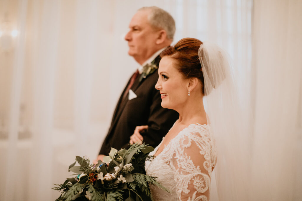 Photo by Pat Cori Photography of a bride and father walking down the aisle. Alexandria Wedding Venue.