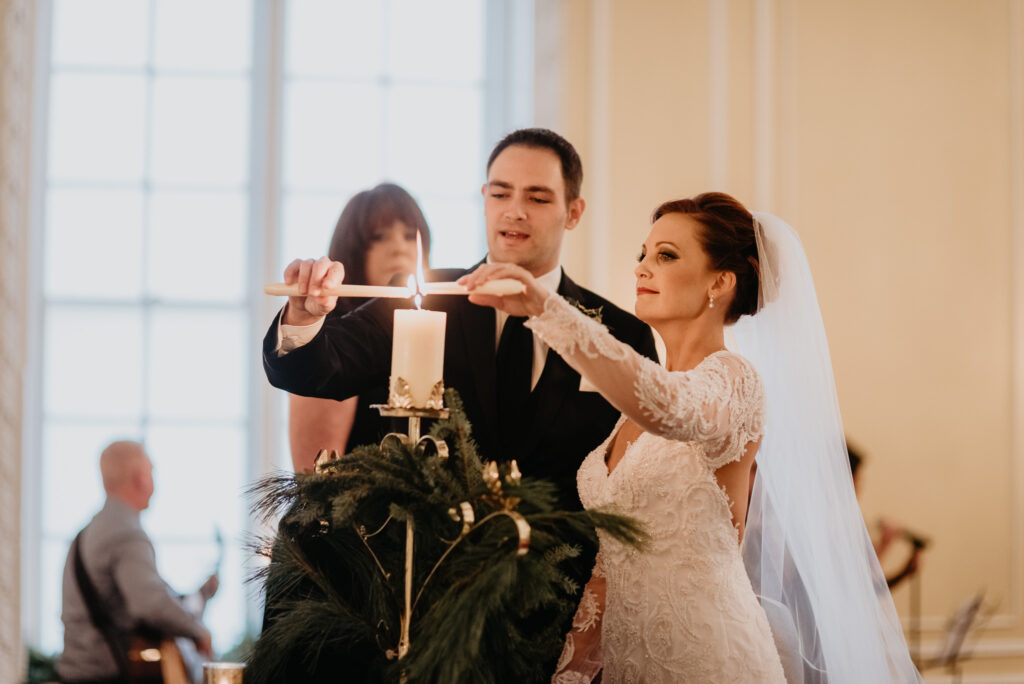 Photo by Pat Cori Photography of a Bride and Groom lighting the unity candle. VA wedding Venue.