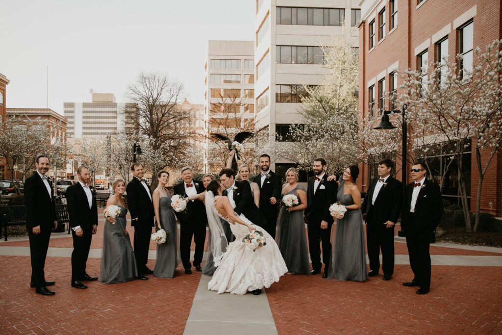 Photo by Pat Cori Photography of a bride and groom and their wedding part in the streets celebrating the wedding. Washington DC Wedding Planners.