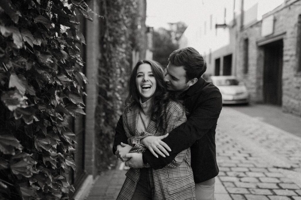 Photo by Pat Cori Photography of a couple hugging celebrating their engagement.