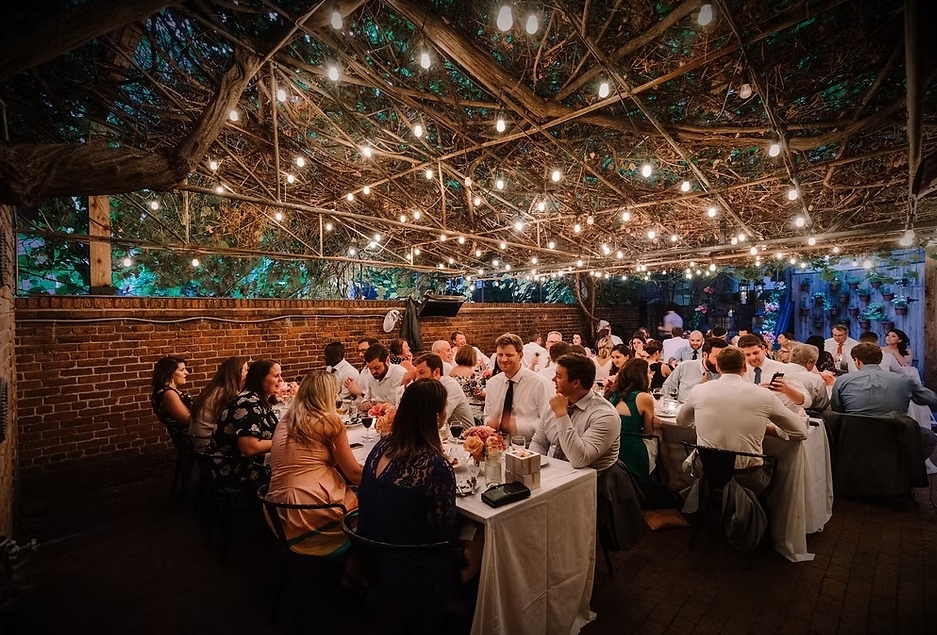 Photo of a group of people enjoying a meal at a restaurant the Iron Gate another date ideas for Washington DC.
