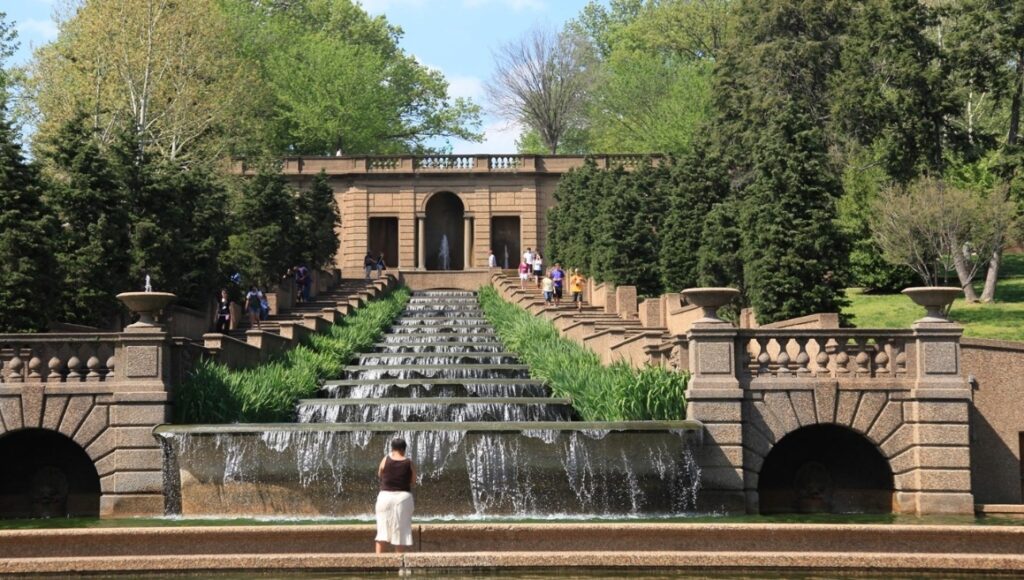 Photo of Meridian Hill Park with a fountain stair step with water flowing down with lush greenery flanking the paths.