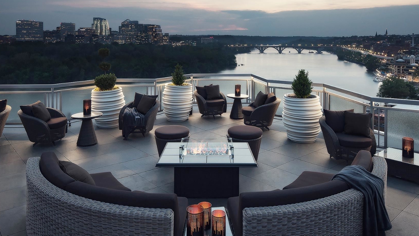 Rooftop Area at the Watergate Hotel with patio furniture looking out over the water. Great things to do in DC.