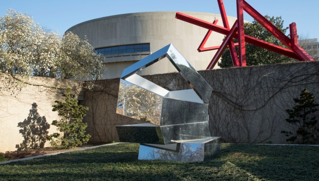 Photo of Hirshhorn Museum Sculpture Garden with sculptures in a mirrored finish surrounded by the grounds many of the date ideas for Washington DC.