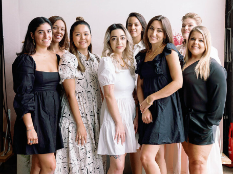 Photo of the team Silk and Slate Co. a Washington DC Wedding Planners posing with a backdrop.