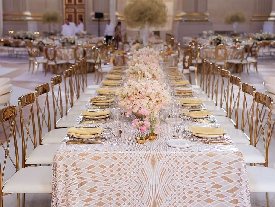 Reception area at the Andrew Mellon Auditorium in DC. Large amounts of tables adorned with table linens, florals and glass stemware. A DC wedding Venue for large weddings.