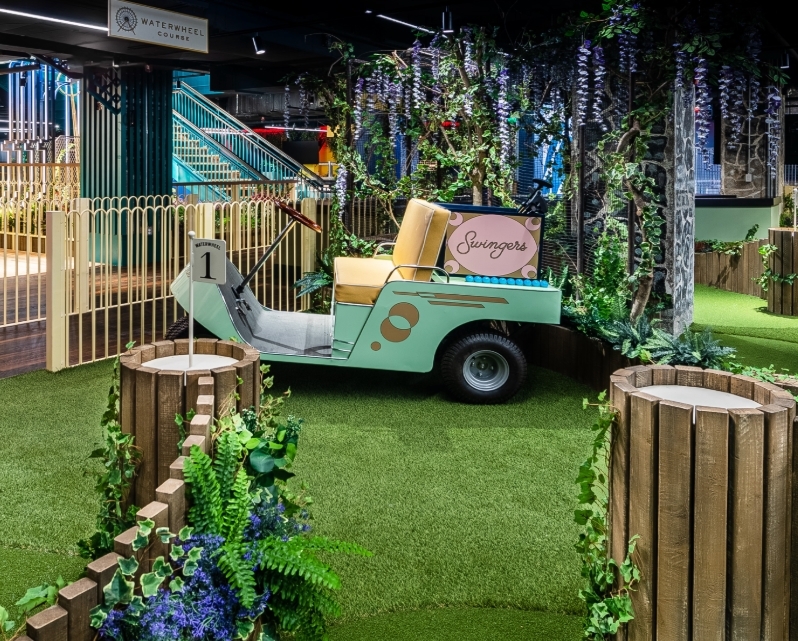 Inside the swinger mini golf course with a golf cart. Great things to do in dc.