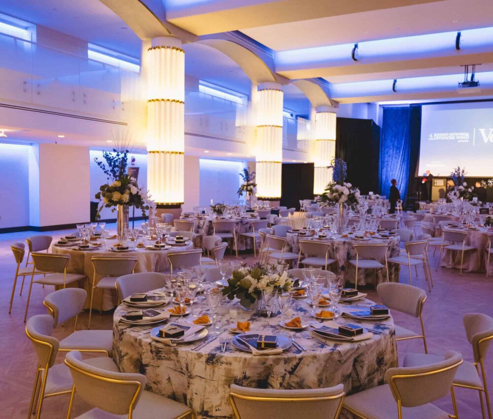 The reception area at The Schuyler DC Events. Large round tables adorned with table linen, florals, glass stemware. A DC wedding Venue.