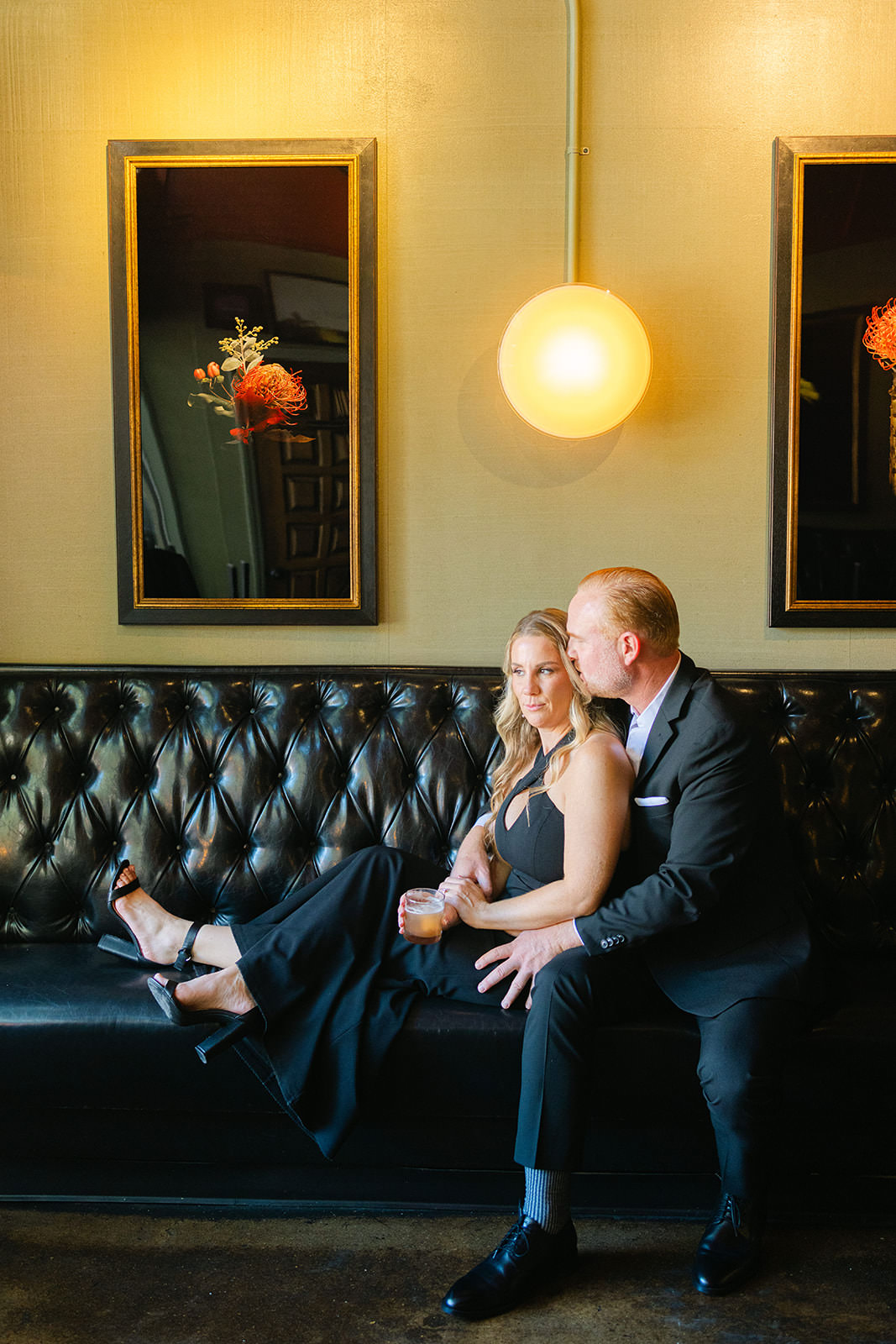 couple sitting on a black couch at Lucky's in Roanoke