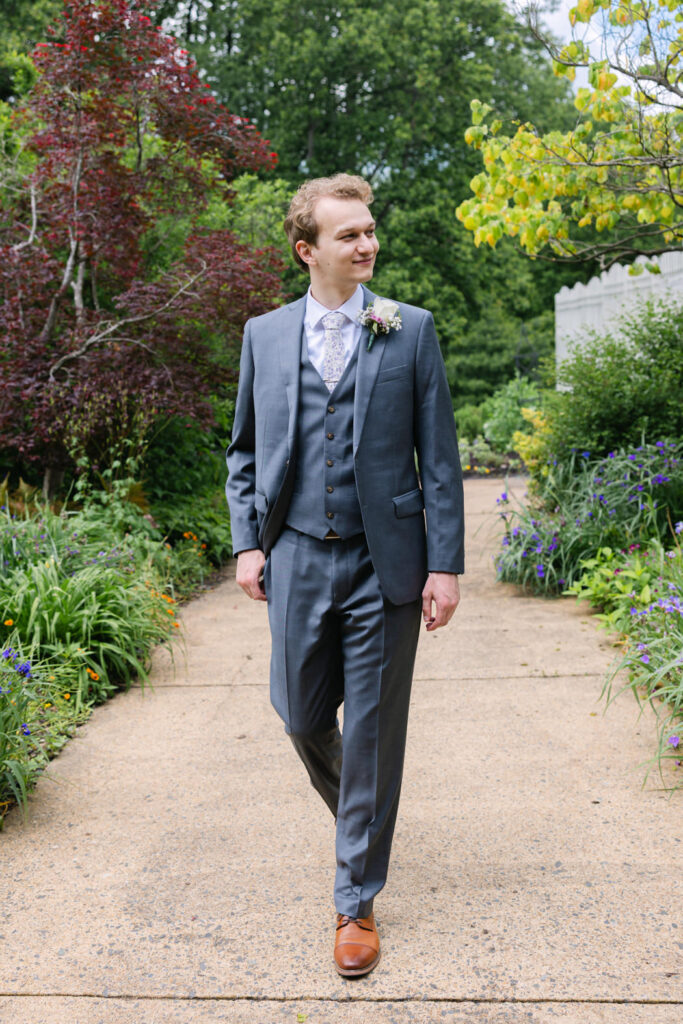 groom walking down the gardens