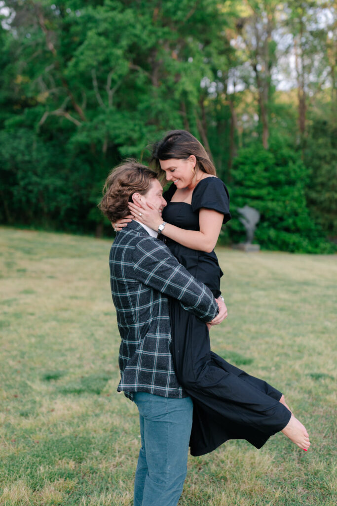 couple spinning during engagement session in comfy engagement photo attire