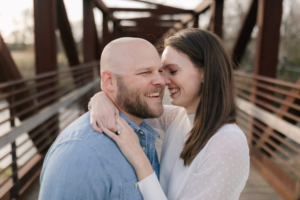 couple smiling on bridge at wasena park in roanoke