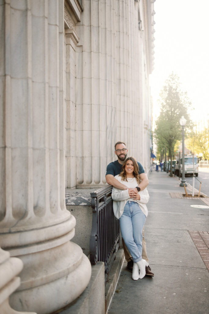 couple hugging in front of historical building in roanoke