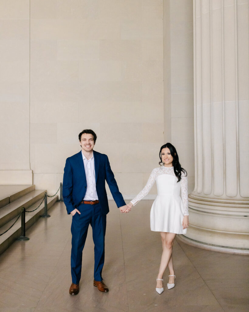 couple posing in their elegant engagement photo attire
 at lincoln memorial in washington DC