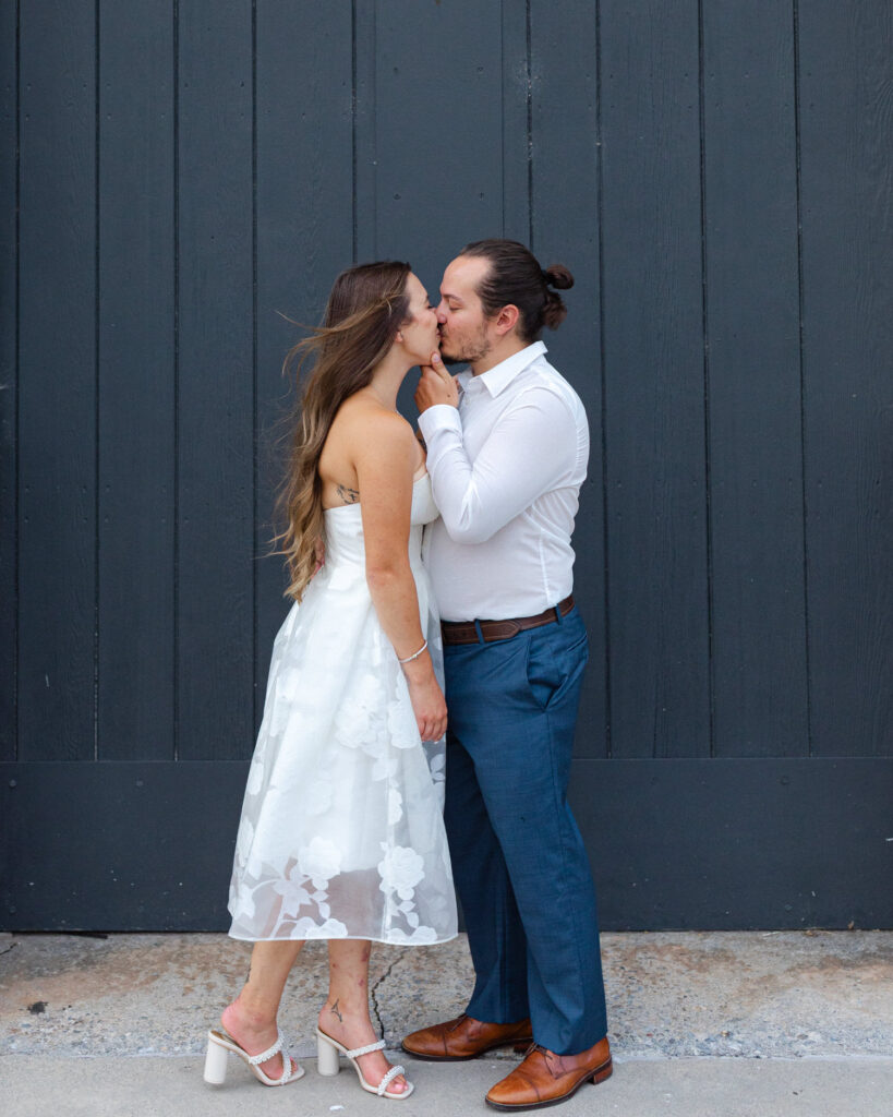 couple kissing in roanoke in front of blue door