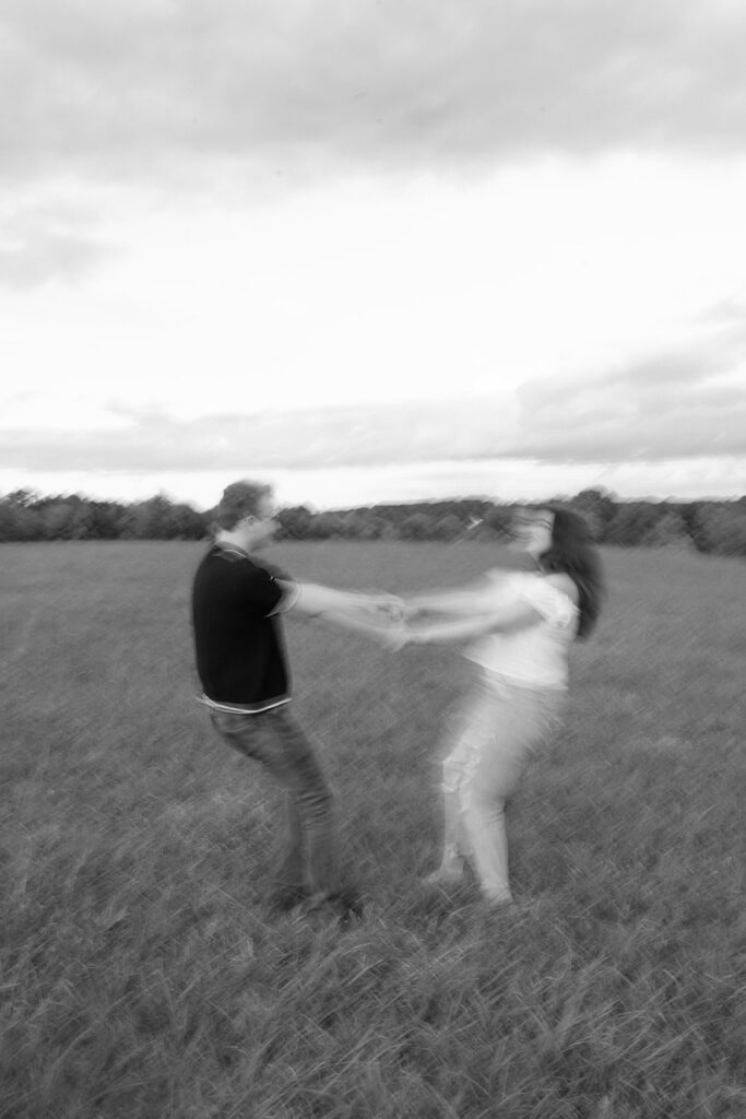 black and white couple spinning during engagement session