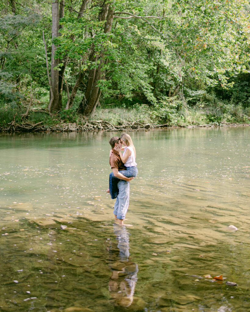 couple hugging in the waters of a river