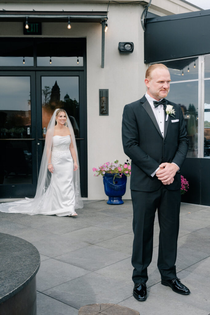 Bride approaching groom during an intimate first look at The Virginian Hotel wedding in Lynchburg, VA