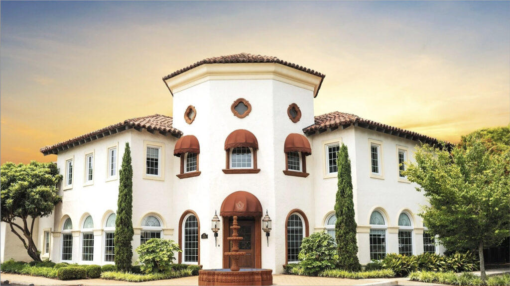 Mediterranean-style wedding venue in Virginia Beach with white stucco exterior, terracotta roof tiles, arched windows, and a front fountain courtyard, ideal for small weddings in Virginia