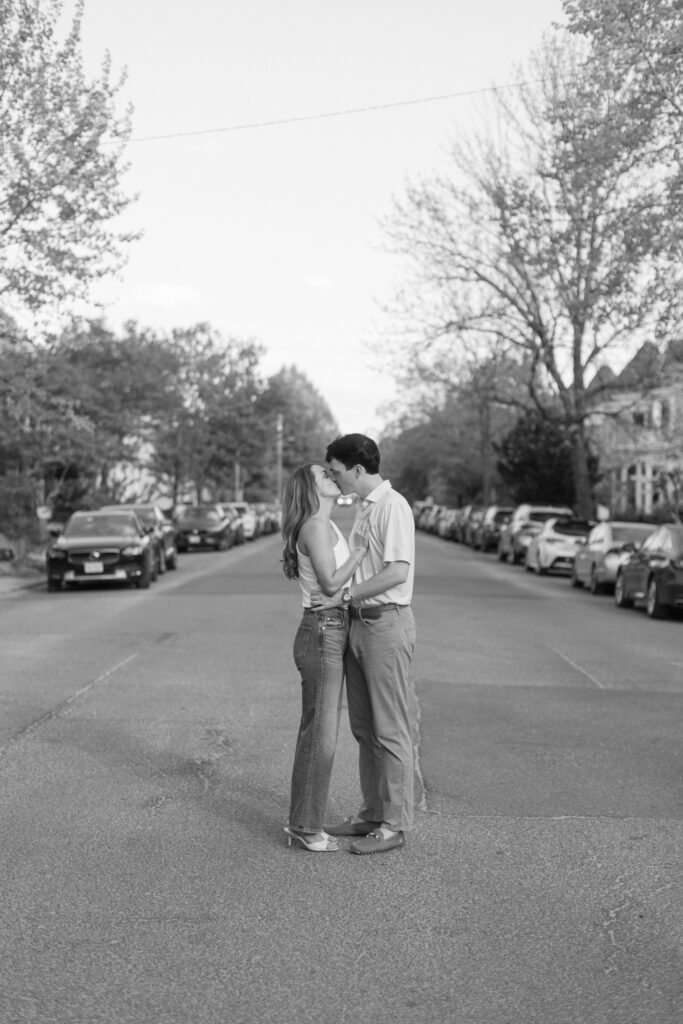 Couple kissing in the middle of a quiet residential street during Downtown Richmond engagement session.