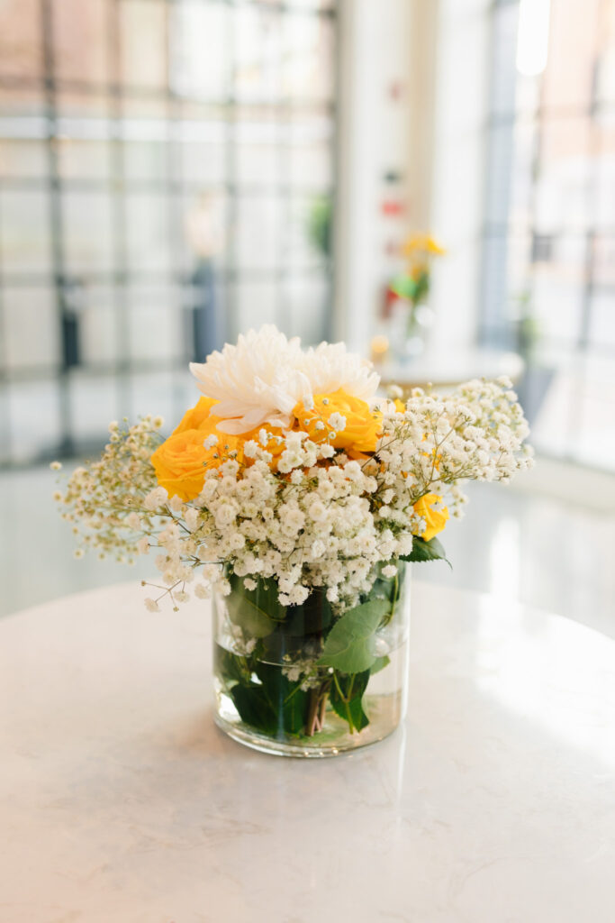 Close-up of yellow roses, white chrysanthemums and baby’s breath from the rehearsal dinner florals by Caroline La Rocca Event & Design