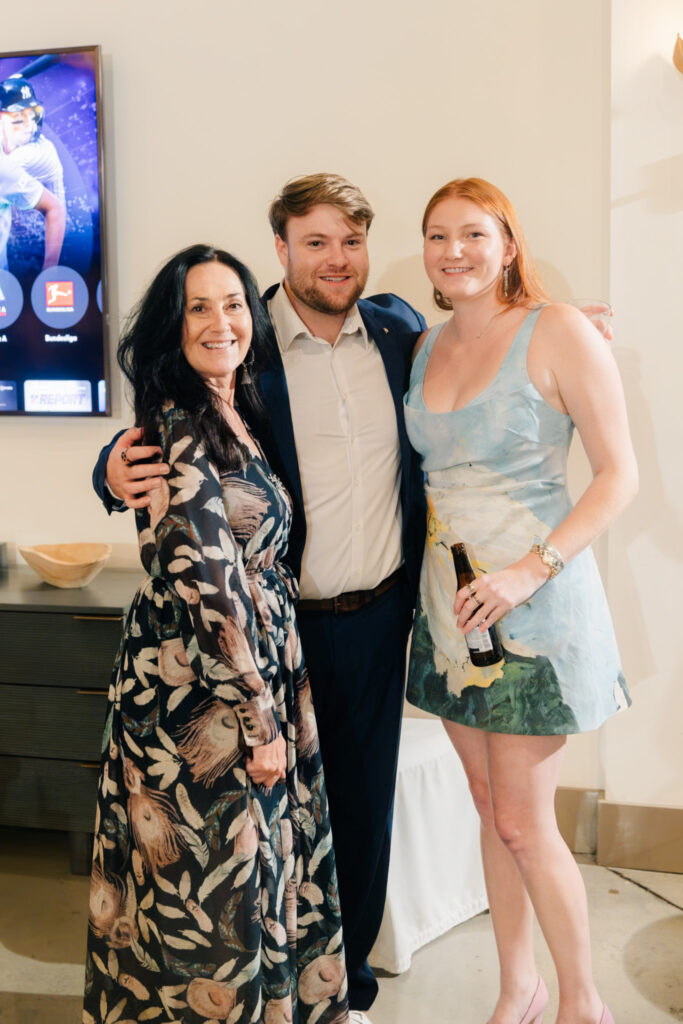 Wedding guests posing together during a relaxed rehearsal dinner at The Georges in Lexington, Virginia