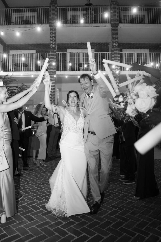 Newlyweds celebrate with guests during their nighttime wedding exit at The Alexandrian Hotel in Old Town Alexandria, Virginia